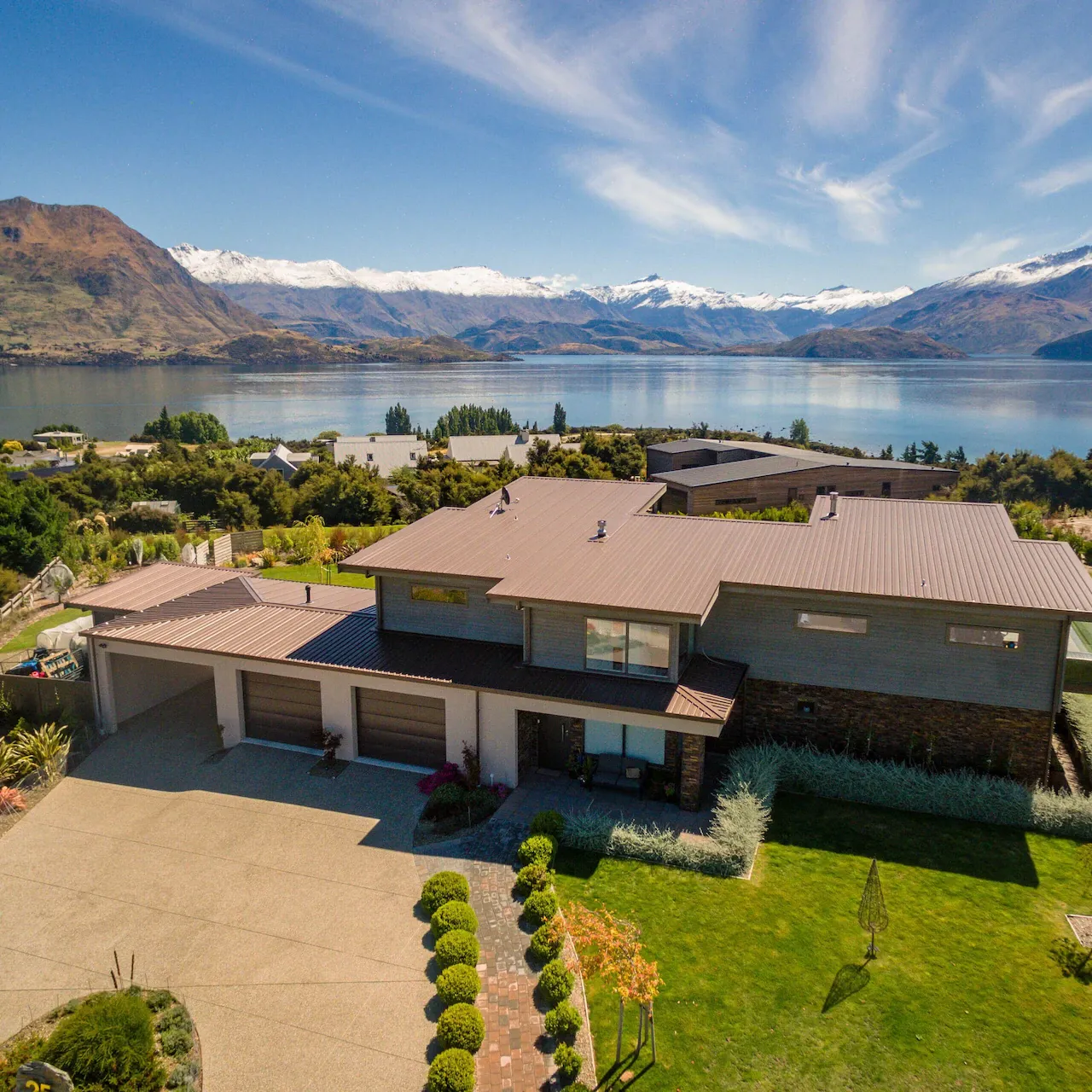 Rooftop view of luxury family bach with a scenic view of the water and mountains